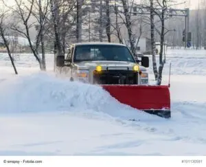 car pickup cleaned from snow by a snowplough during wintertime