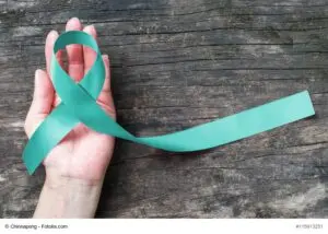 Teal ribbon awareness to support Ovarian/Cervical Cancer on human hand support