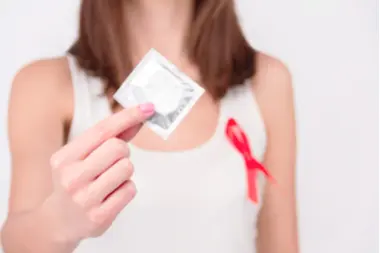 woman holding condom