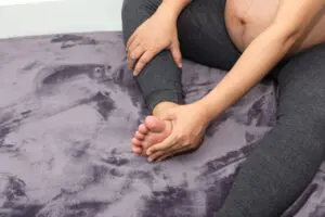 Foot swelling during pregnancy woman feeling pain 