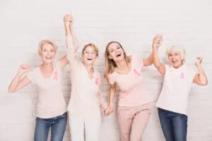 women wearing pink breast cancer ribbons. 