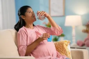 pregnant woman taking medication.