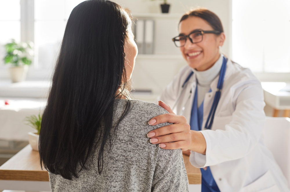 woman talking to female patient.